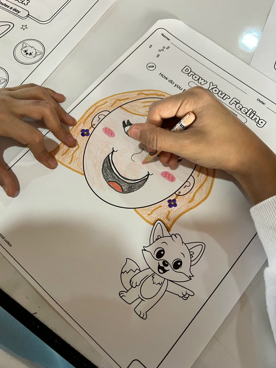 A child coloring a face on a Draw Your Feeling page